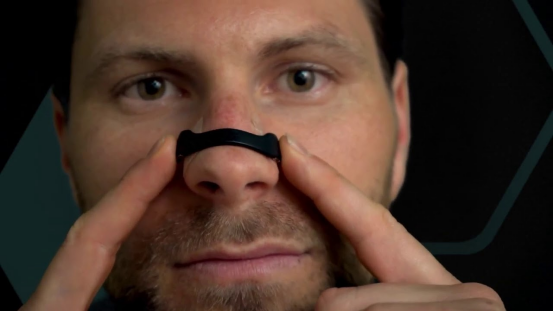 Nasal strips on a person's nose, illustrating their use for better breathing.