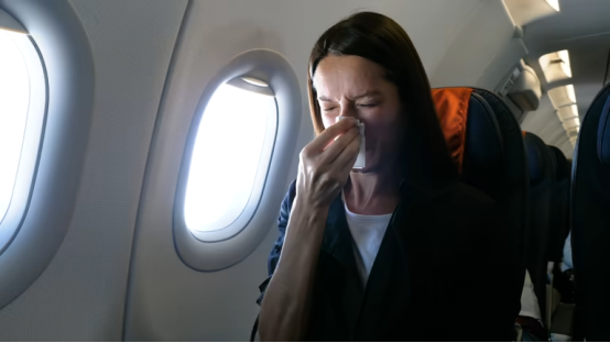 Traveler using nasal strips for nasal congestion relief at a rest stop