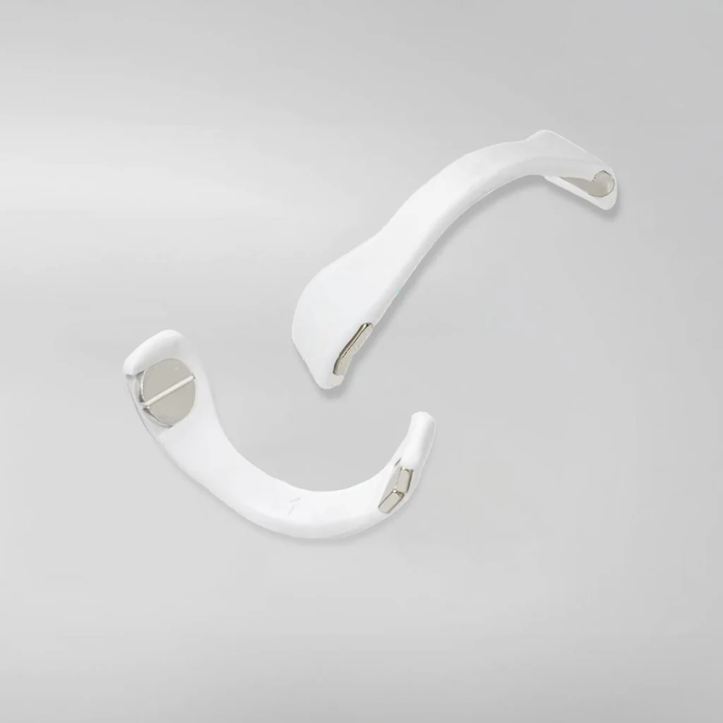 White magnetic nasal strips with metal details for clear breathing.